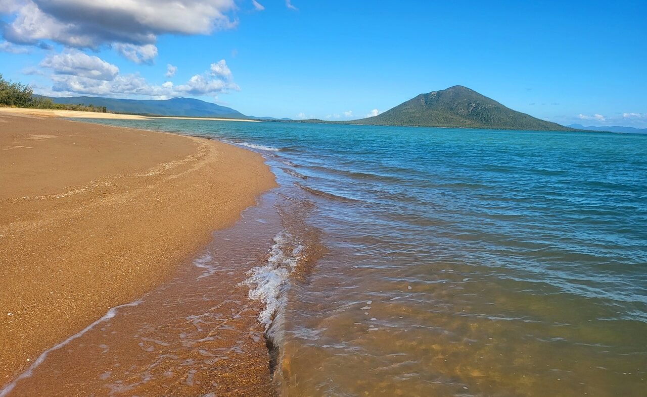 Gentle-waves-sunset-beach Gentle lapping waves on a beach in the Whitsundays