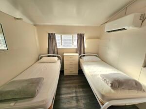 Sunset Beach Bungalows showcasing two single beds with Air conditioning